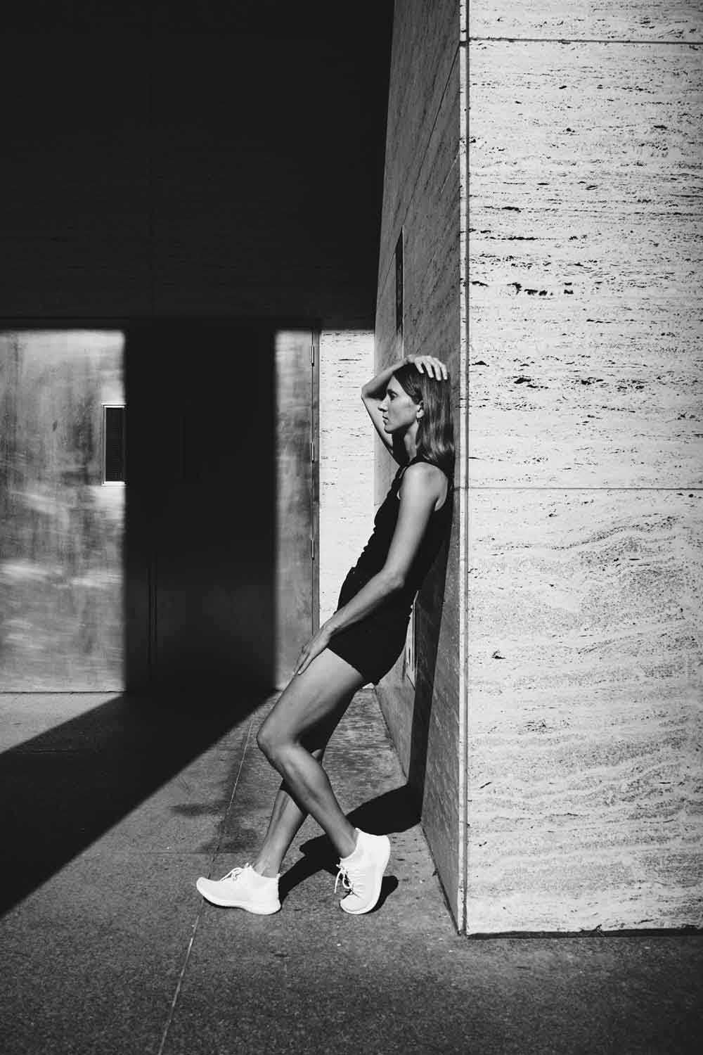 Woman leaning against the wall looking stylish